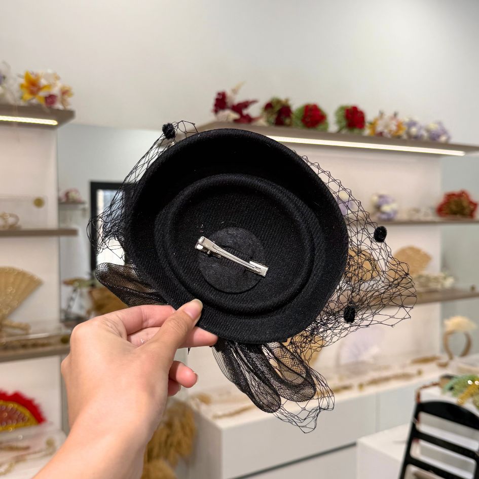 Chapeau de cérémonie noir avec voile et fleurs