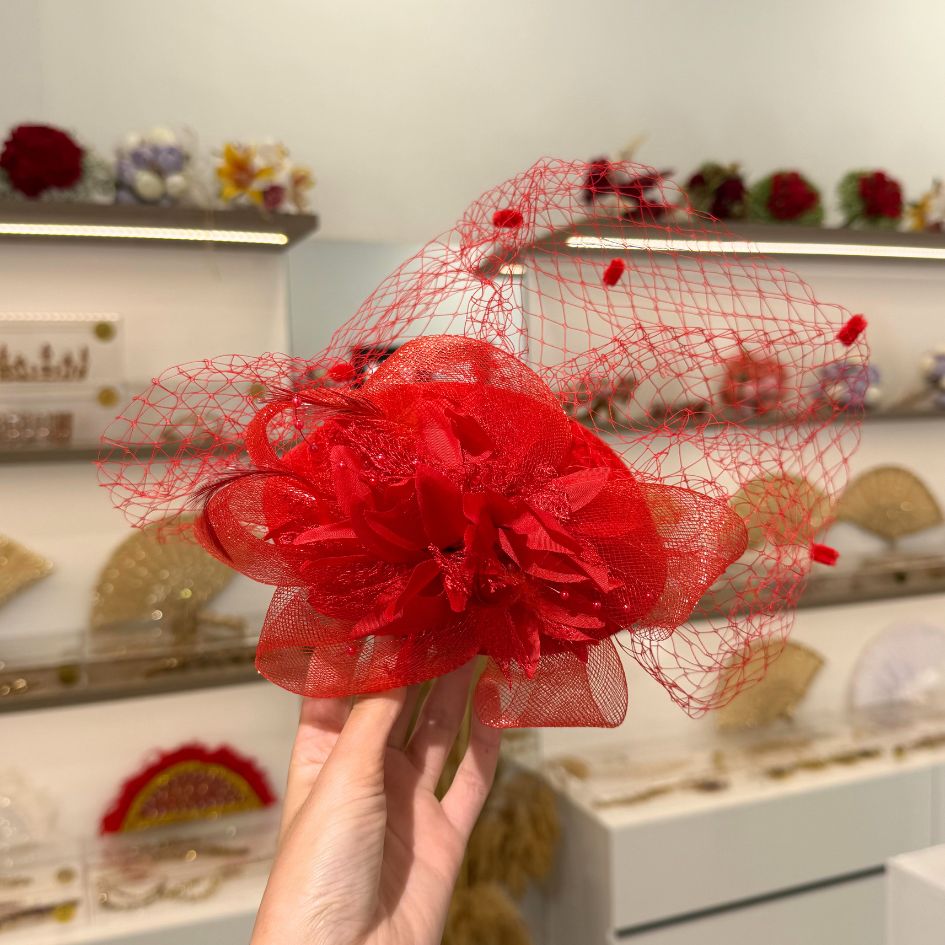 Chapeau de cérémonie rouge avec voile et fleurs